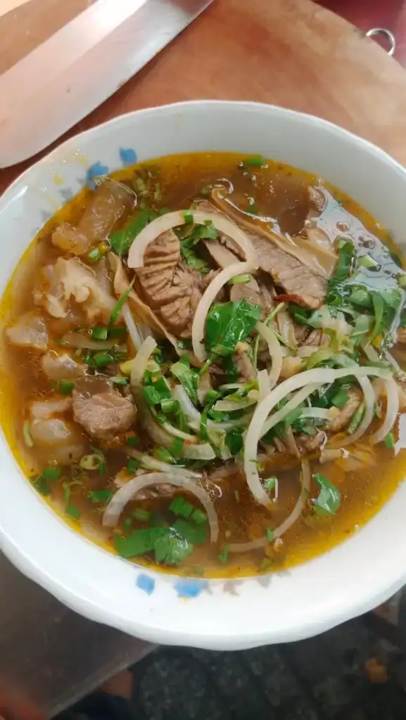A bowl of bun bo Hue - it's a must try during the 2 Week Vietnam Itinerary to sample Hue's famous spicy beef noodle soup