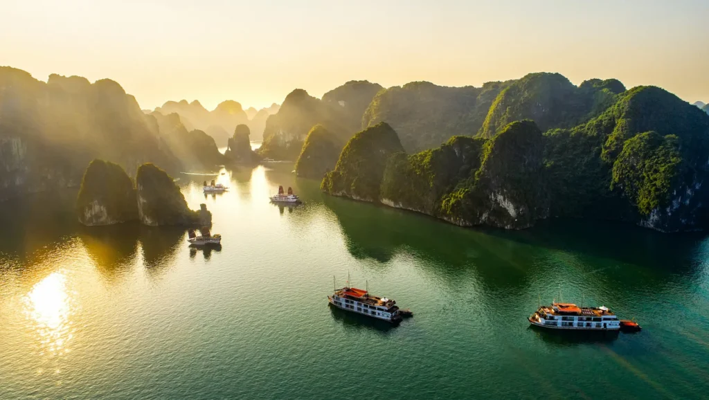 'Best Ha Long Bay cruise sailing through limestone karsts at sunset