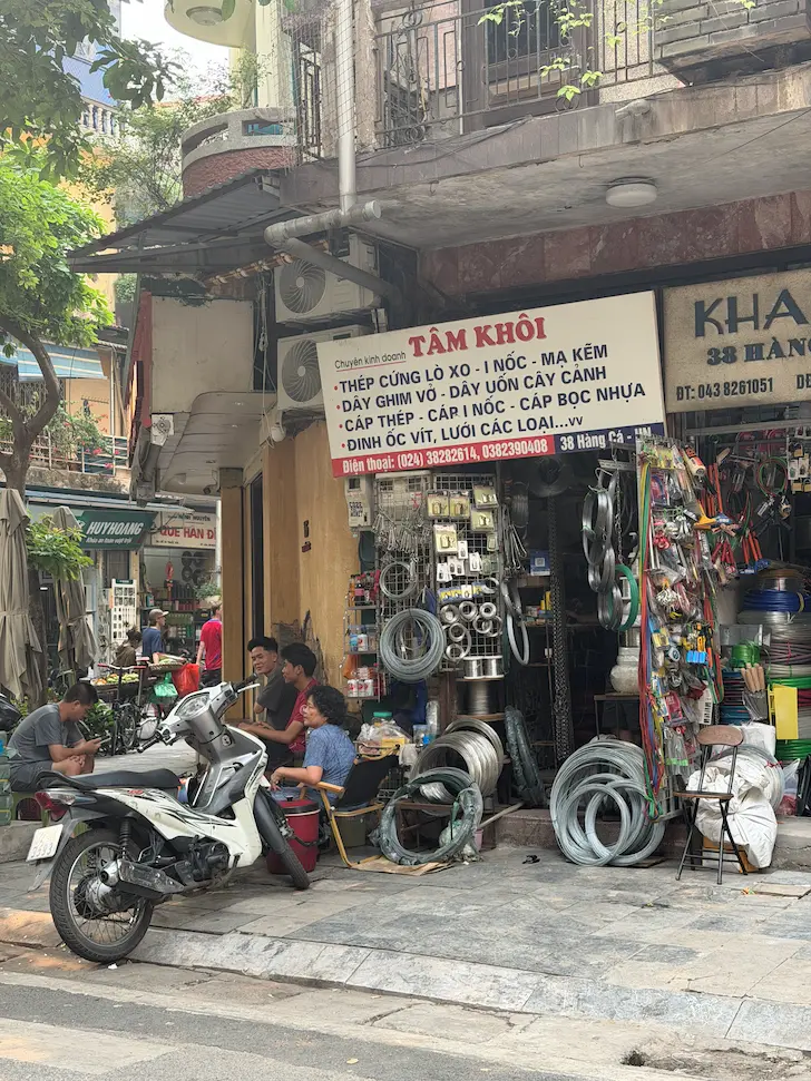 Locals hanging out outside a shop in the Old Quarter Hanoi