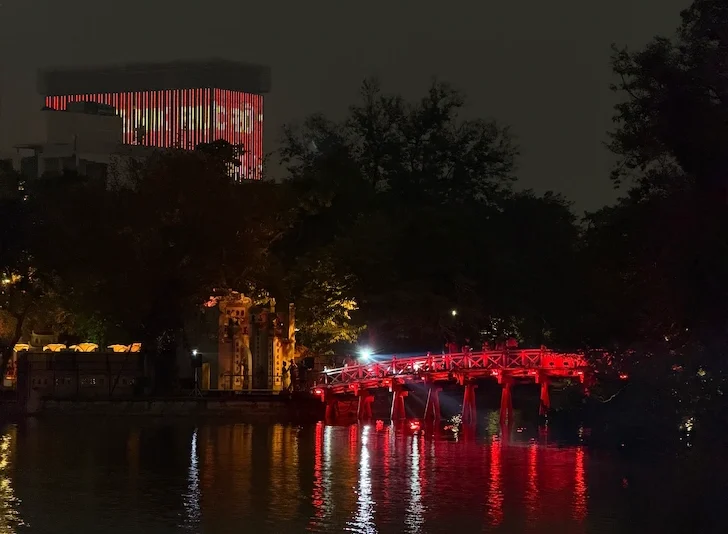 The Huc Bridge leading to Ngoc Son Temple on Hoan Kiem Lake illuminated at night